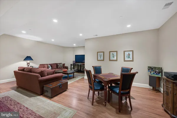 a living room with furniture a wooden floor and a bookshelf