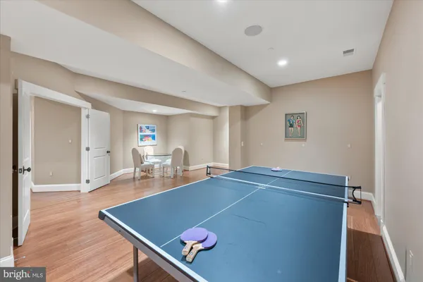 a room with furniture pool table and window