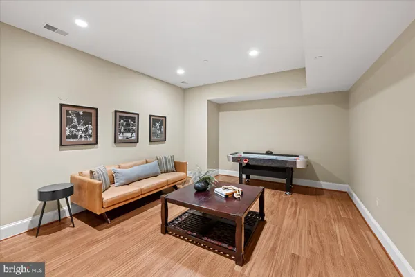 a living room with furniture and a wooden floor