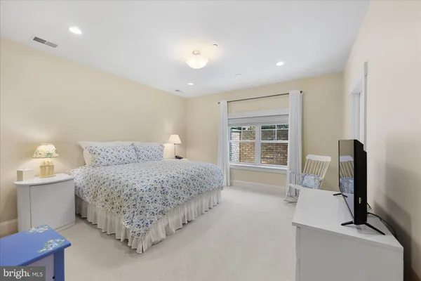 a bathroom with a sink a toilet and shower a mirror