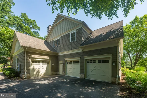 a front view of a house with a yard table and chairs