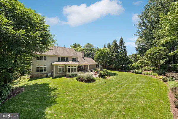 a front view of a house with a yard table and chairs