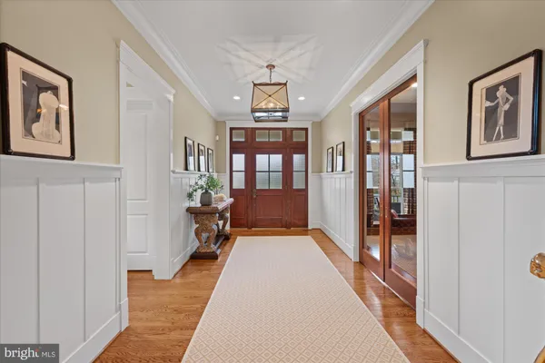 a hallway of a livingroom with furniture and window