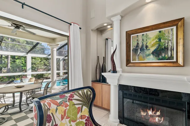 a living room with fireplace furniture and a floor to ceiling window