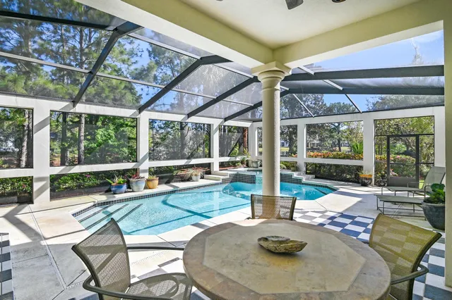 a bathroom with a granite countertop sink a toilet a mirror and shower