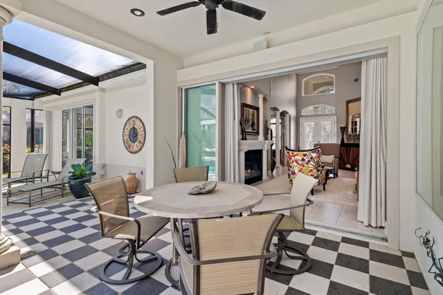 a bathroom with a granite countertop sink a toilet a mirror and bathtub