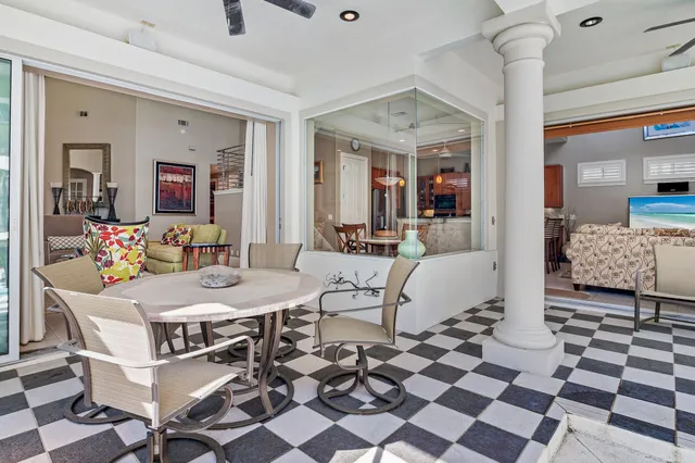 a bedroom with a bed a dresser and painting on the wall