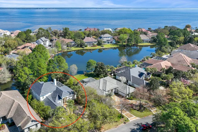a front view of a house with lots of flowers planted