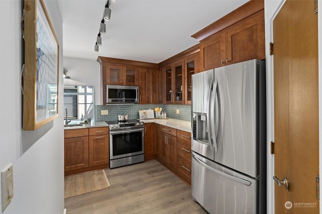 a kitchen with stainless steel appliances granite countertop a refrigerator and a sink