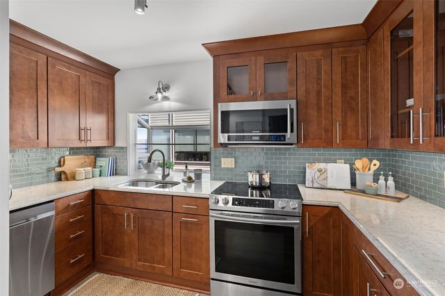a kitchen with a sink a cabinets and window
