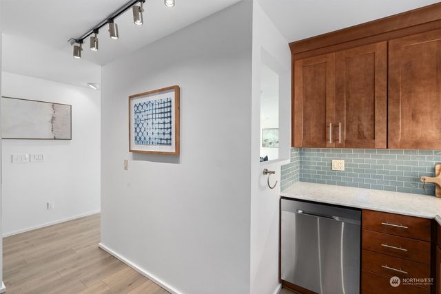 a bedroom with a bed and a large mirror on the dresser