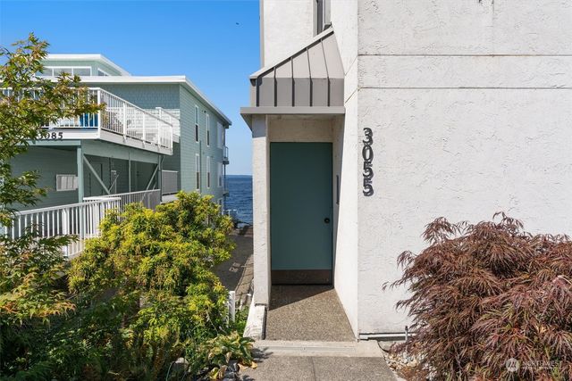 a living room with furniture and floor to ceiling window