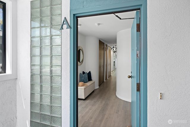 a living room with furniture fireplace and a large window