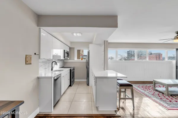 a large white kitchen with a large window