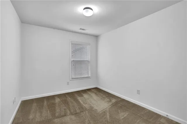 an empty room with a empty space and windows