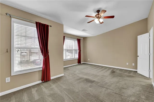 a view of a livingroom with a ceiling fan and window
