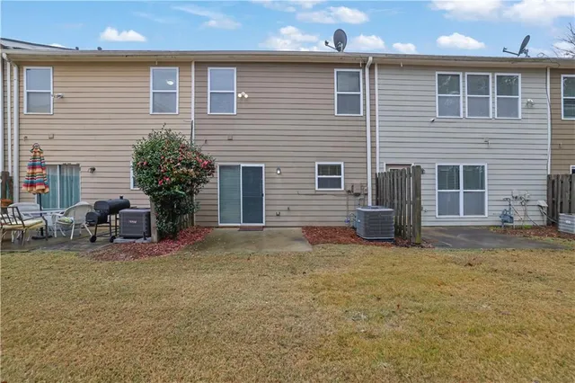 a view of a house with backyard and sitting area