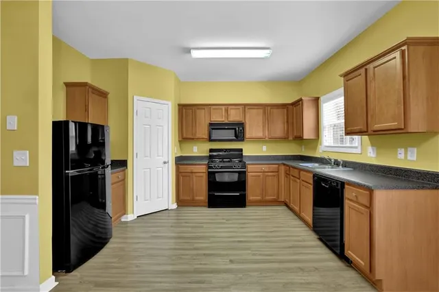 a kitchen with a refrigerator and a stove top oven