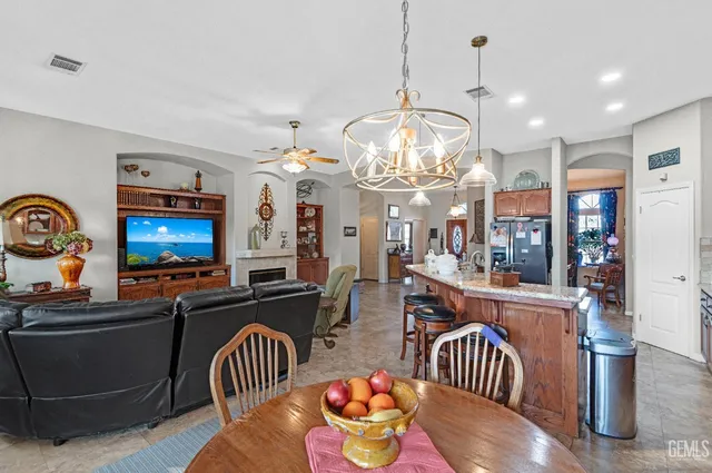 a view of a dining room with furniture a chandelier and wooden floor