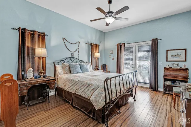 a bedroom with a bed wooden floor and window