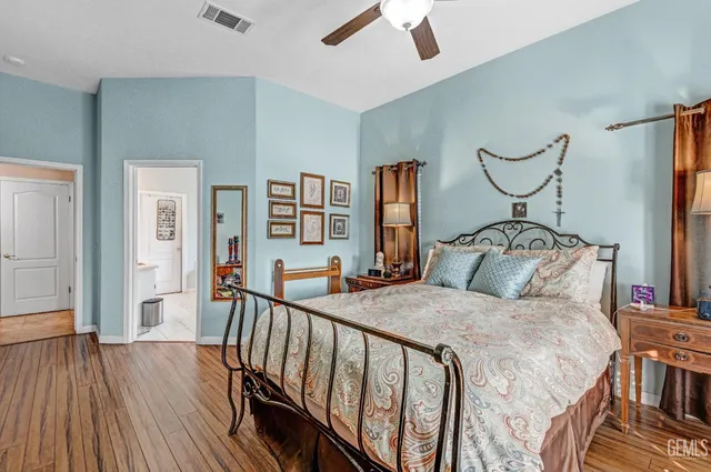 a bedroom with a bed and wooden floor