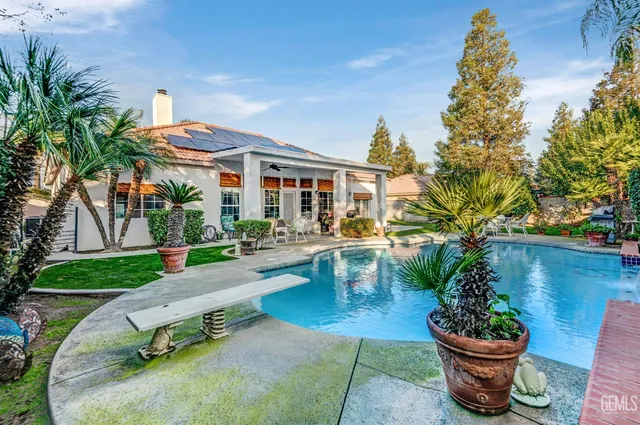 a white bench sitting in front of a house