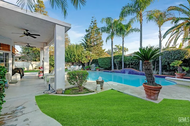 a view of a swimming pool with a table and chairs