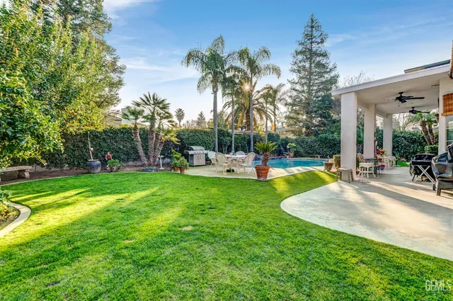 a view of a swimming pool with a table and chairs