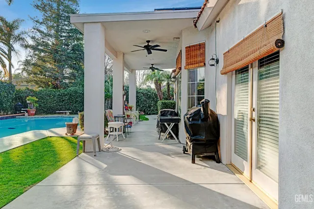 a view of a porch with chairs and a yard
