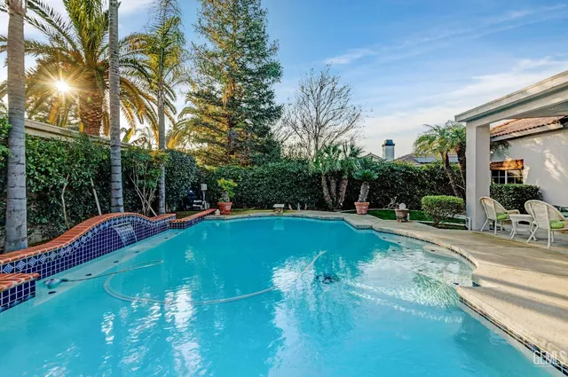 a view of a swimming pool with a yard