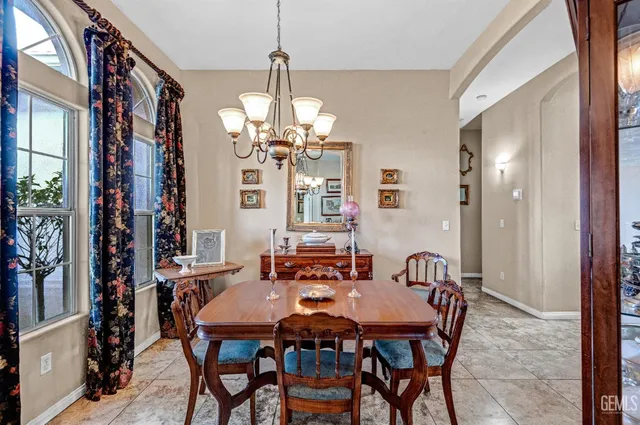 a view of a dining room with furniture and chandelier