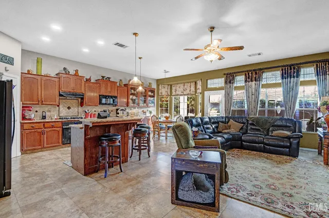 a living room with lots of furniture and kitchen view