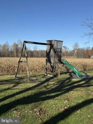 a view of a yard with two chairs and a table