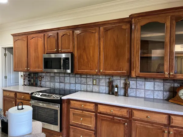 a kitchen with stainless steel appliances granite countertop a sink stove and cabinets