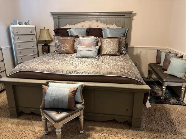 a bedroom with a bed and a television