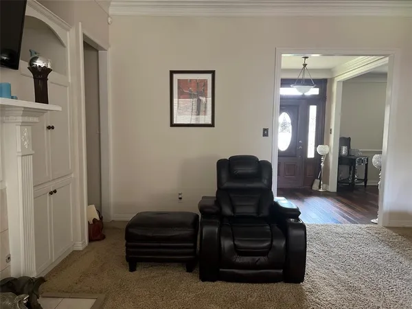 a living room with furniture and a mirror