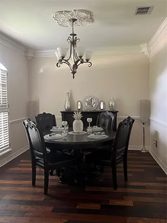 a view of a dining room with furniture wooden floor and chandelier