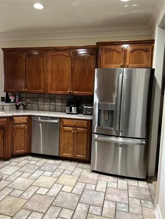 a kitchen with stainless steel appliances granite countertop a stove a sink dishwasher and a refrigerator