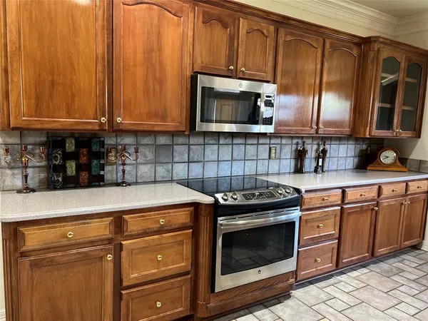 a kitchen with granite countertop cabinets stainless steel appliances and a sink