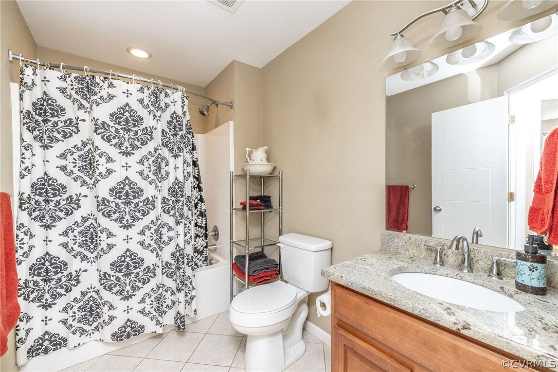 4952 Shannon Road Kents Store, VA 23084 - Photo 24 of 40 a bathroom with a granite countertop toilet a sink a mirror a shower and a window
