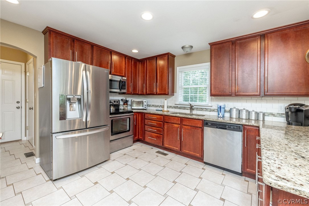 4952 Shannon Road Kents Store, VA 23084 - Photo 4 of 40 a kitchen with granite countertop stainless steel appliances and wooden cabinets