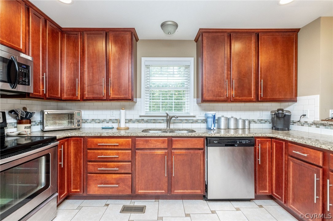4952 Shannon Road Kents Store, VA 23084 - Photo 5 of 40 a kitchen with stainless steel appliances granite countertop wooden cabinets a sink and dishwasher a oven with granite countertops