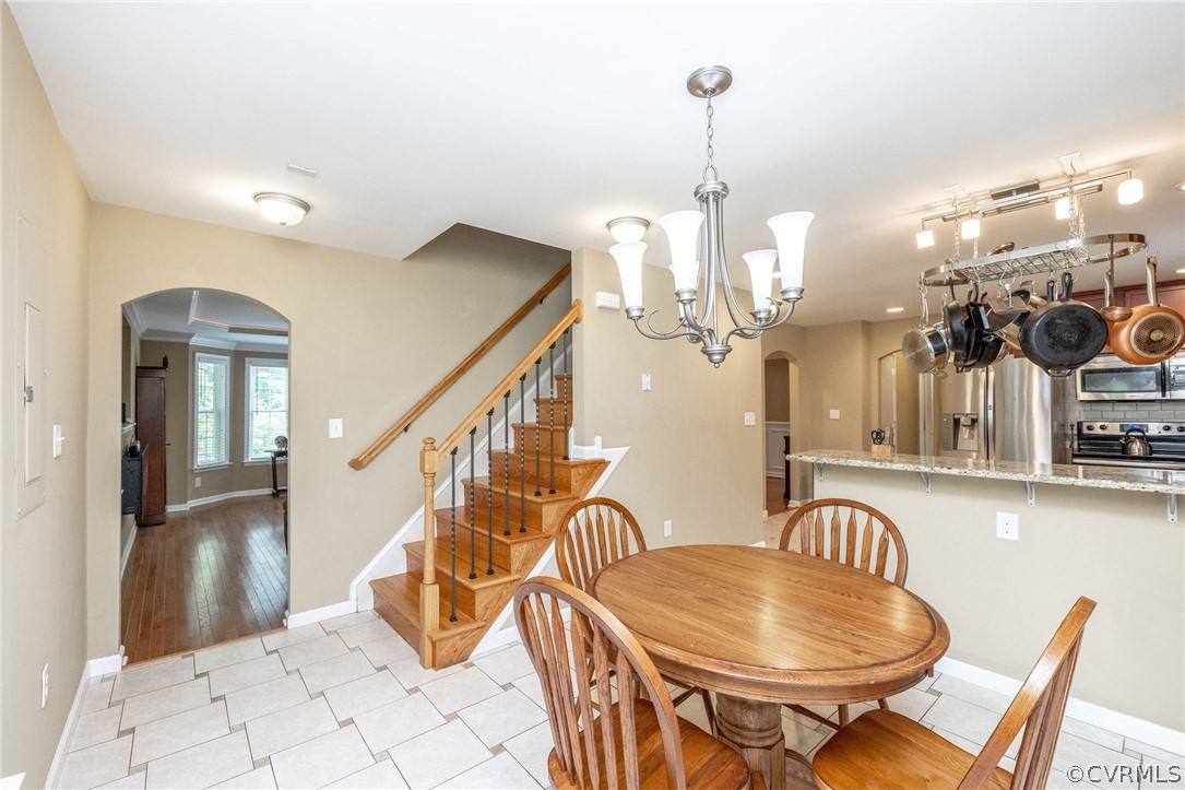 4952 Shannon Road Kents Store, VA 23084 - Photo 8 of 40 a dining room with furniture a chandelier and wooden floor