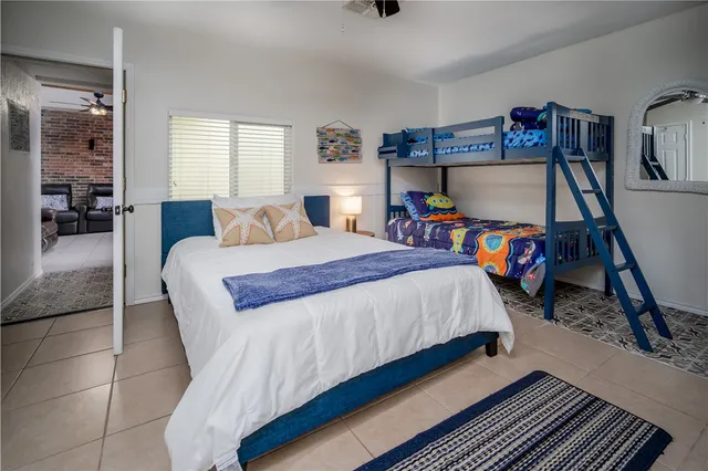 a bedroom with a bed and a wooden floor