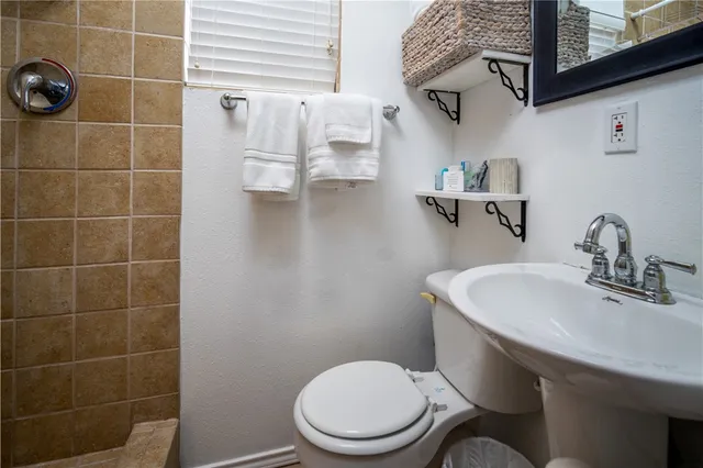 a bathroom with a toilet sink and shower