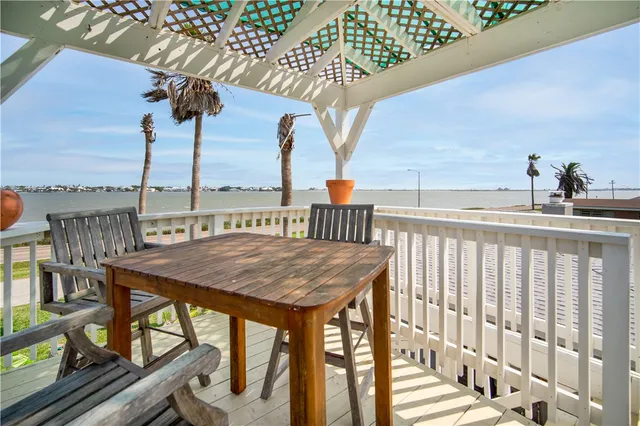 a view of a balcony with furniture and a potted plant