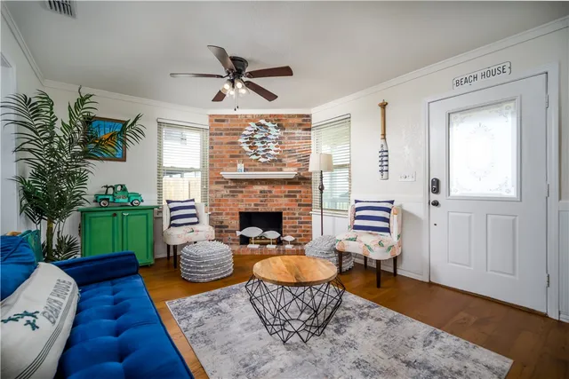 a living room with furniture fireplace and a potted plant