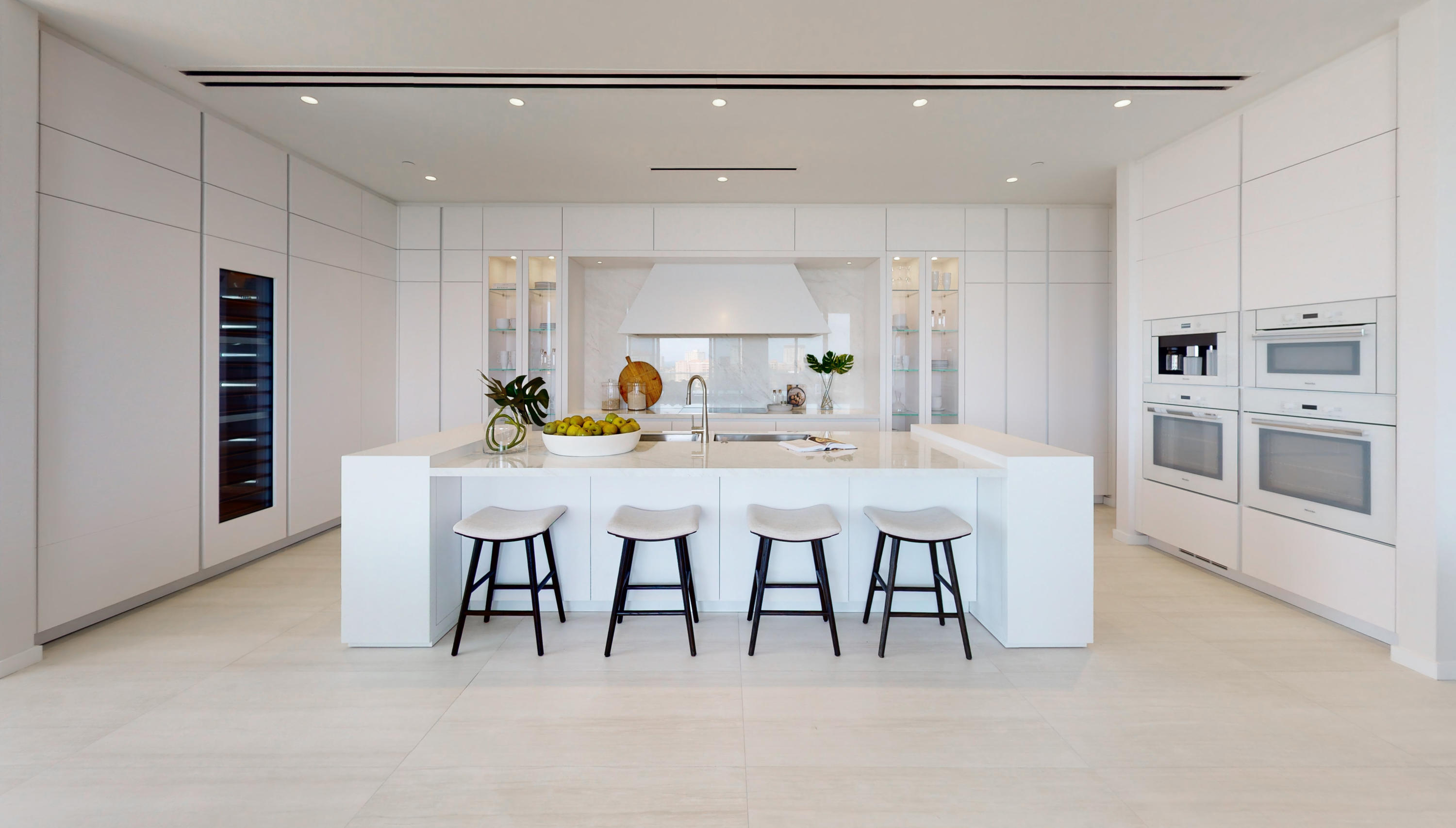 200 Southeast Mizner Boulevard, Unit PH18 Boca Raton, FL 33432 - Photo 26 of 49 a dining room with furniture and a kitchen view