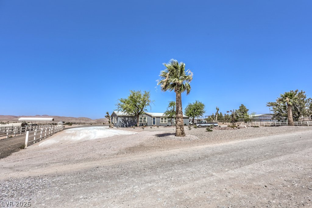 4375 Pinwheel Street Logandale, NV 89021 - Photo 3 of 52 A rural retreat with desert landscaping and clear skies.