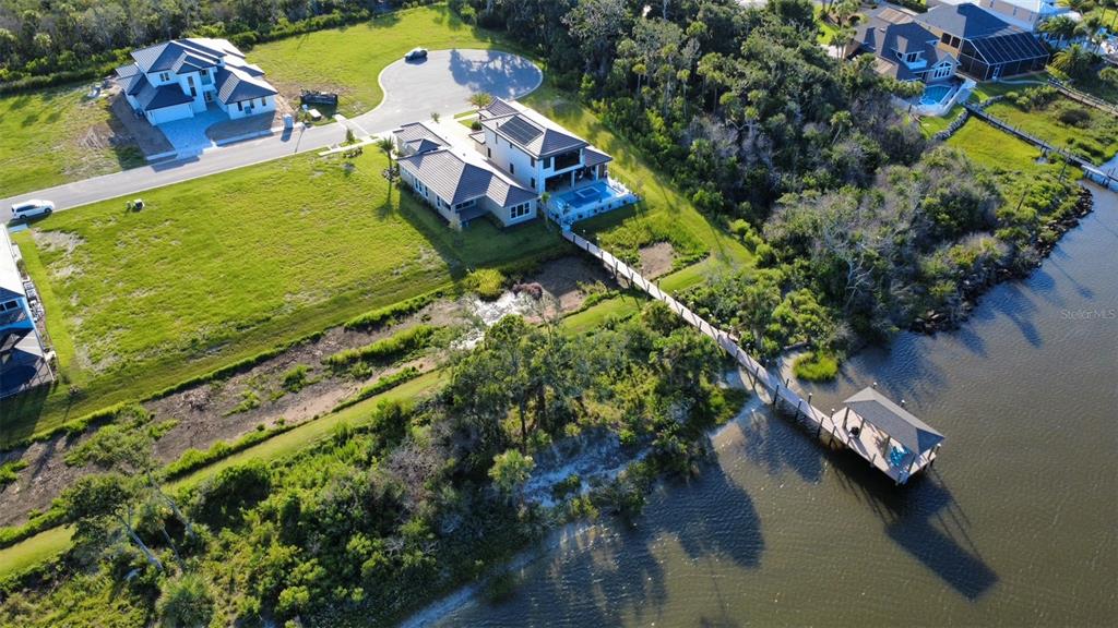 4 Coronado Road Flagler Beach, FL 32136 - Photo 4 of 30 an aerial view of a house with a garden and lake view